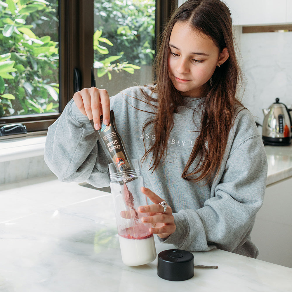 Girl making welly kids instant smoothie chocberry shake