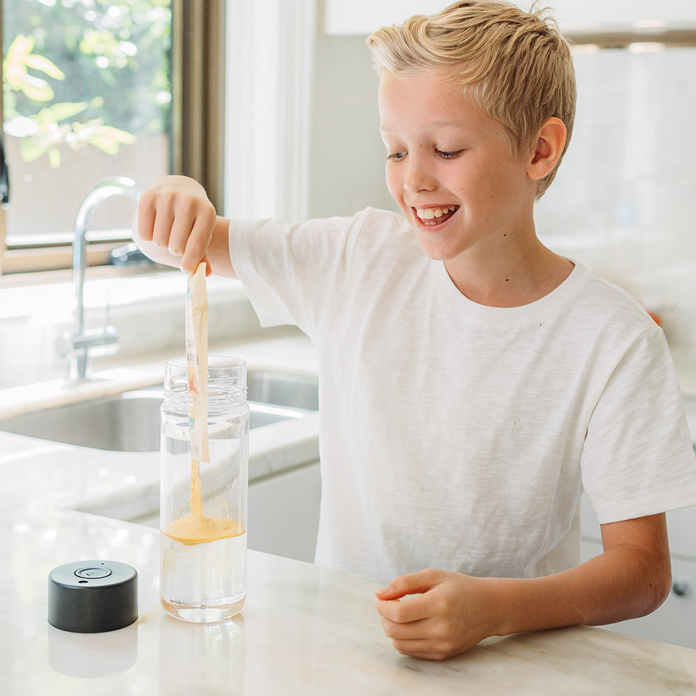 Boy making Welly Kids instant smoothie Tropicool Punch